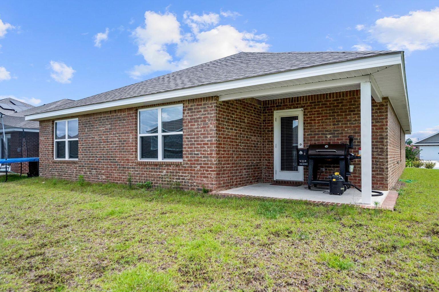 816 Moorhen Way Crestview, FL 32539 - Photo 2 of 19 a view of a chair and table in backyard of the house