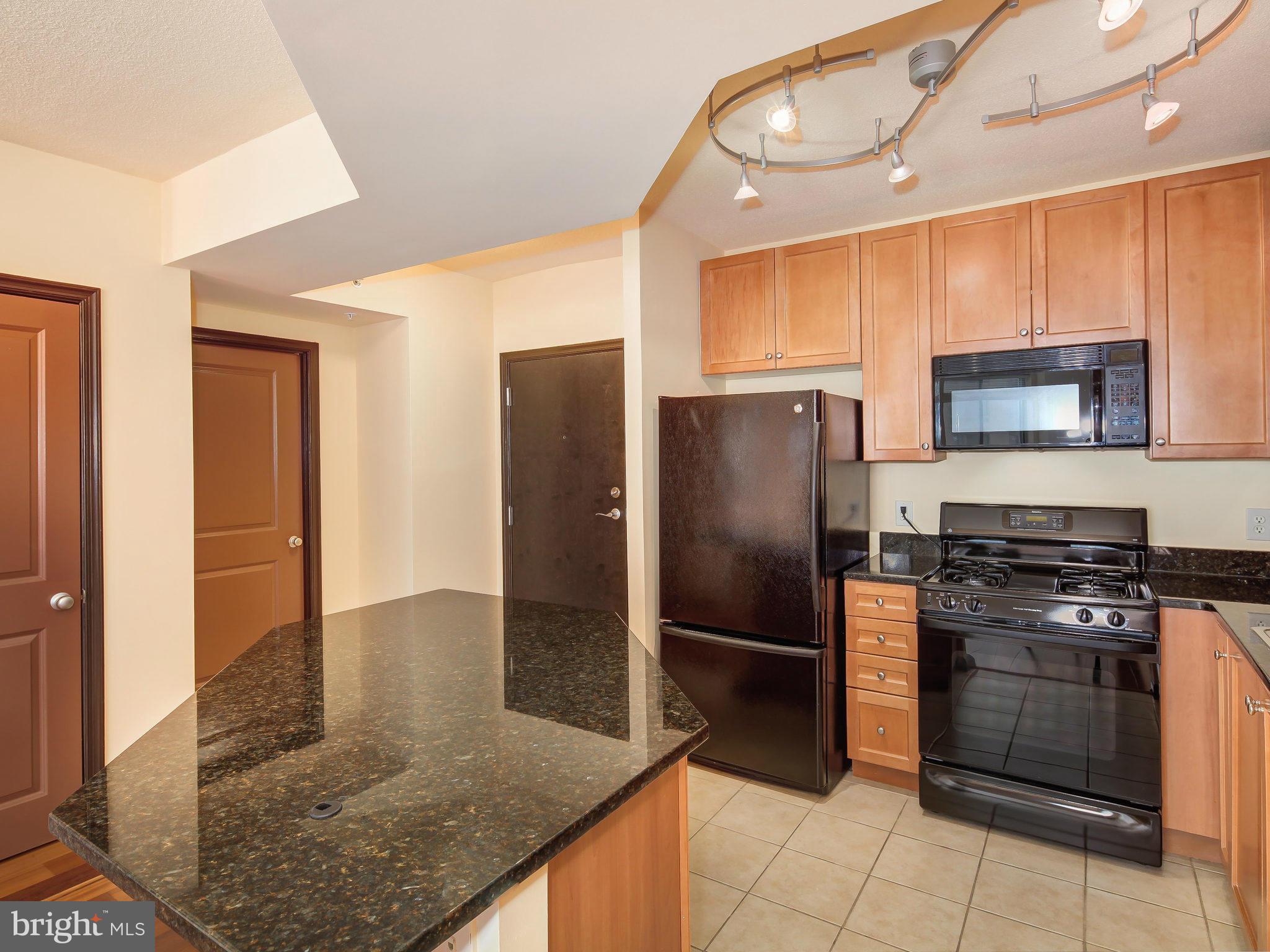 851 North Glebe Road, Unit 921 Arlington, VA 22203 - Photo 15 of 29 a kitchen with stainless steel appliances granite countertop a refrigerator a stove and a sink