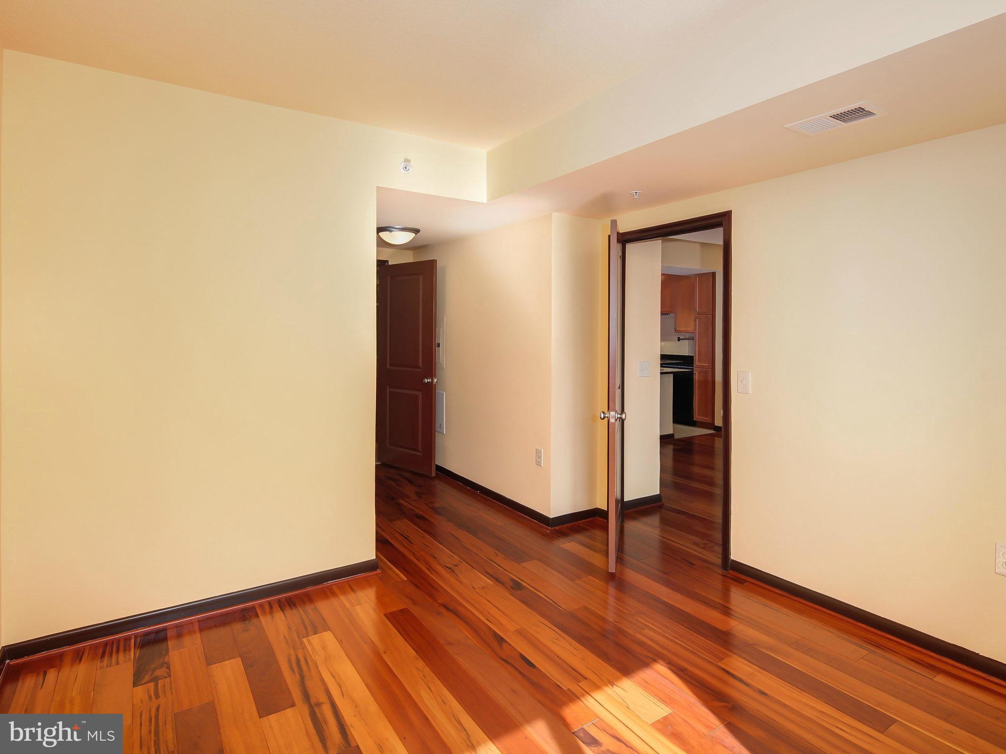 851 North Glebe Road, Unit 921 Arlington, VA 22203 - Photo 17 of 29 a view of an empty room with wooden floor