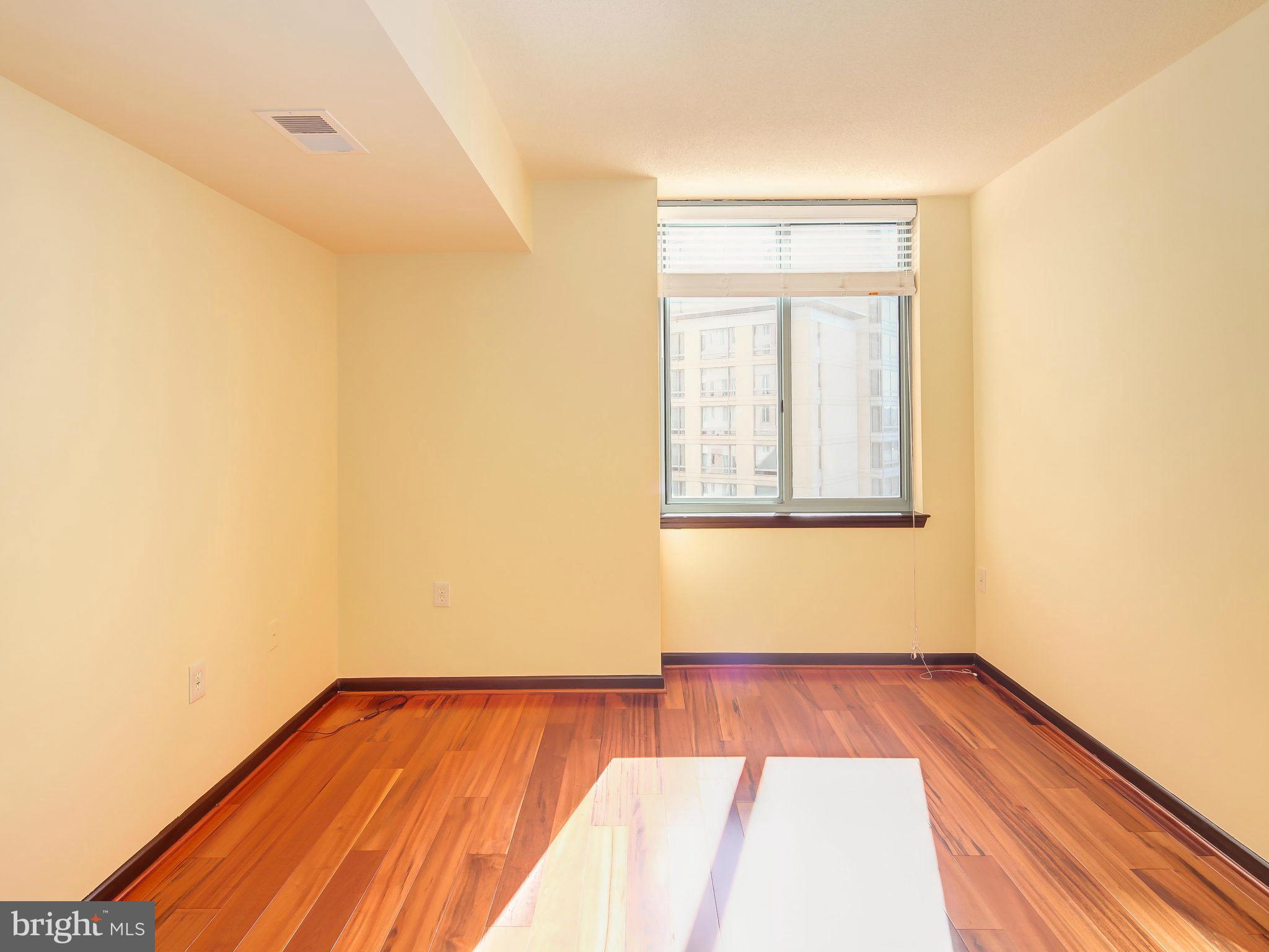 851 North Glebe Road, Unit 921 Arlington, VA 22203 - Photo 19 of 29 a view of empty room with wooden floor and fan