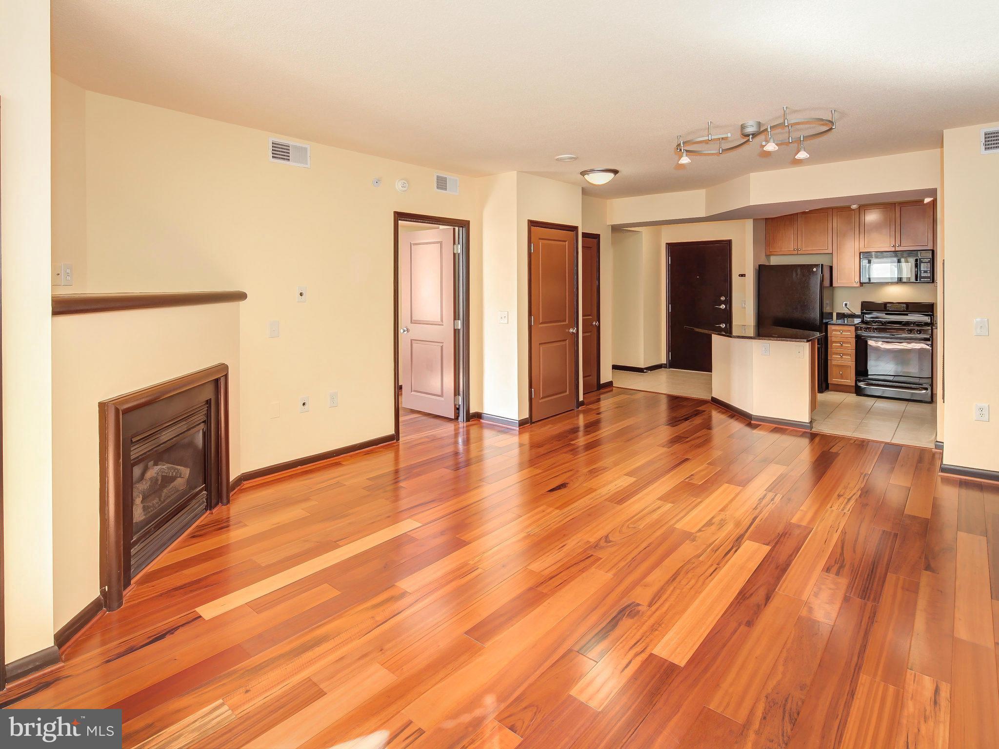 851 North Glebe Road, Unit 921 Arlington, VA 22203 - Photo 5 of 29 a view of a living room kitchen with furniture and wooden floor