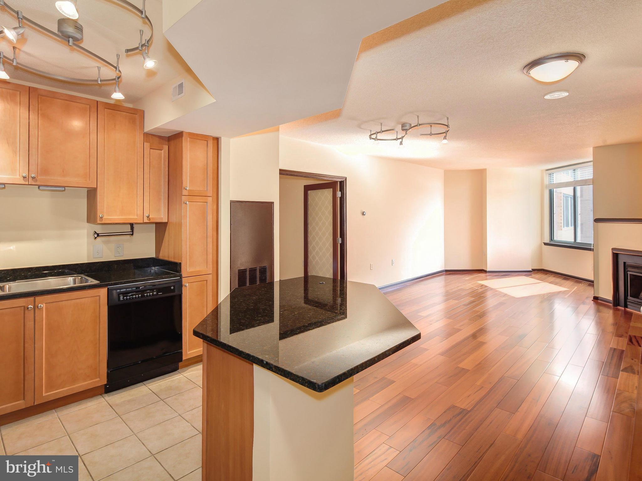 851 North Glebe Road, Unit 921 Arlington, VA 22203 - Photo 7 of 29 a kitchen with stainless steel appliances granite countertop a stove a sink and a refrigerator