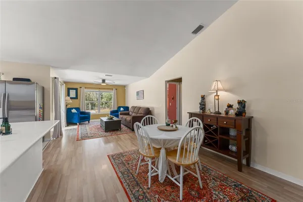 a dining room with furniture and wooden floor