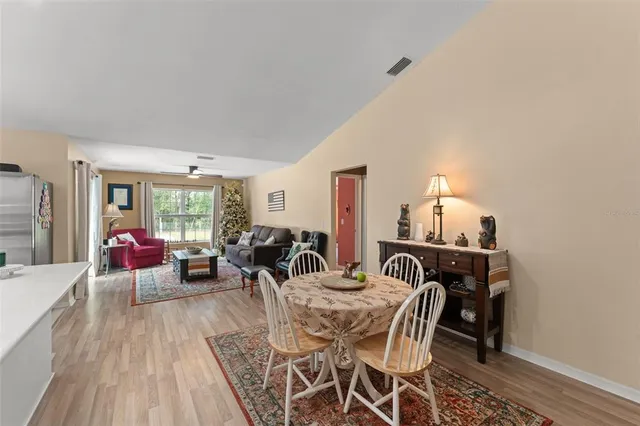 a living room with furniture kitchen view and a refrigerator