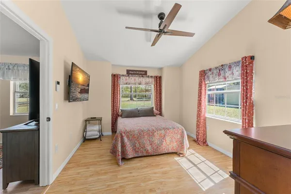 a view of a room with wooden floor and furniture