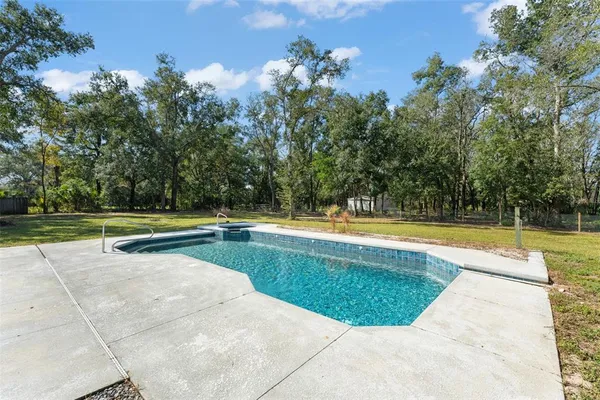 a backyard of a house with large trees
