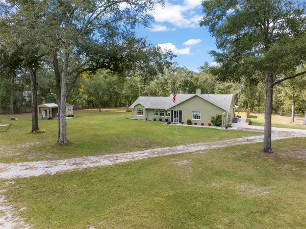 a front view of house with yard and green space