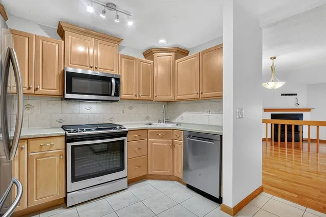 a view of an empty room with closet and a window