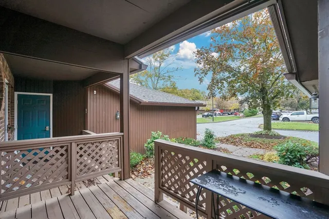 a view of empty room with wooden floor and fireplace