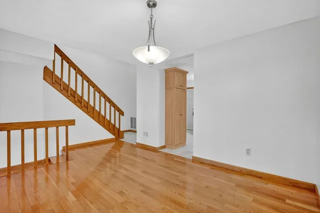 a kitchen with stainless steel appliances granite countertop white cabinets a refrigerator and a stove top oven