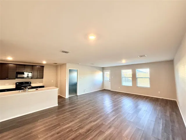 a view of a kitchen with a sink and a stove top oven