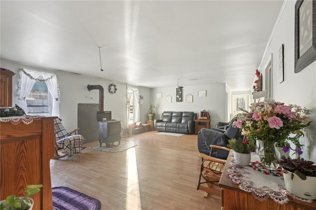 2753 Hemlock Lake Road Rossiter, PA 15772 - Photo 16 of 50 a living room with furniture a chandelier and a wooden floor