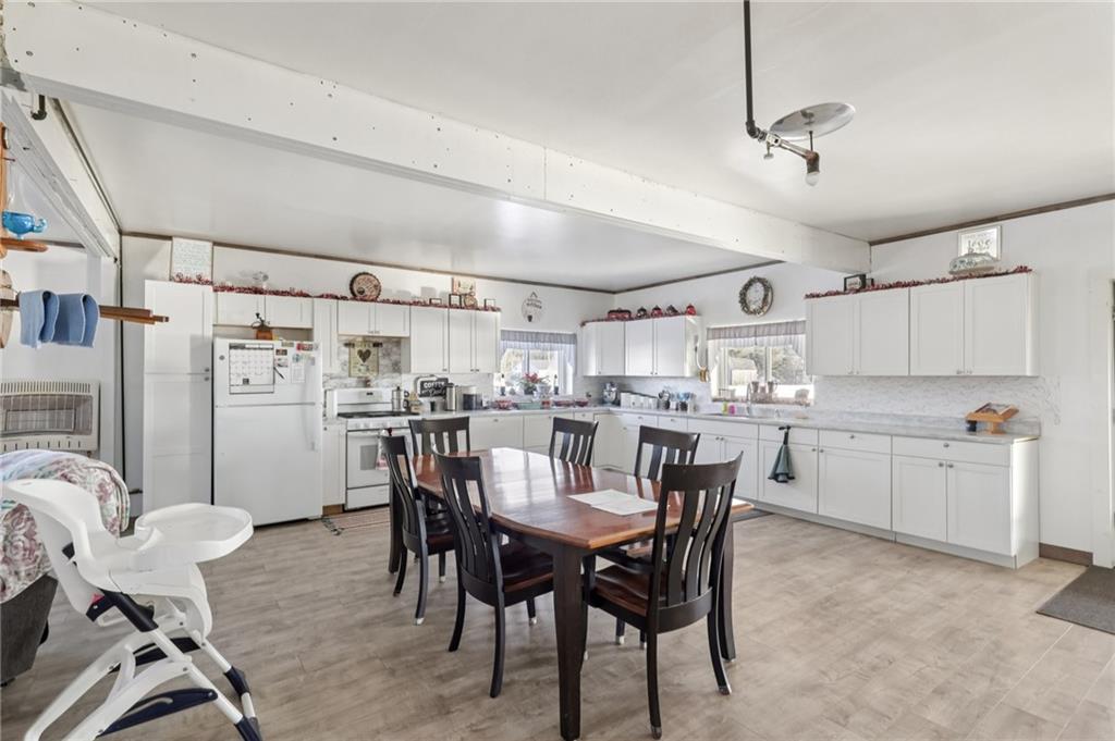 2753 Hemlock Lake Road Rossiter, PA 15772 - Photo 5 of 50 a kitchen with a dining table chairs refrigerator and cabinets