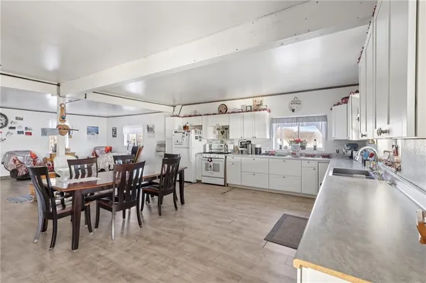 a kitchen with lots of wooden furniture appliances and cabinets