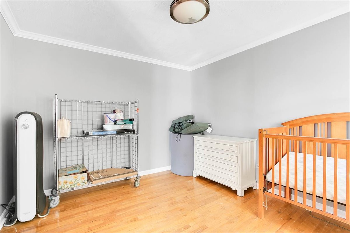663 Primrose Lane Matteson, IL 60443 - Photo 11 of 32 a view of a room with wooden floor and windows