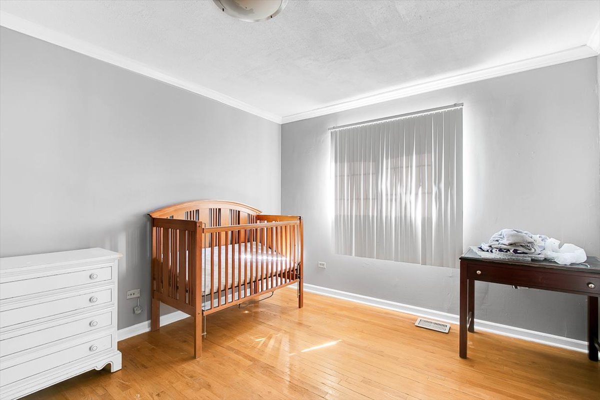 663 Primrose Lane Matteson, IL 60443 - Photo 12 of 32 a bedroom with a bed and a window