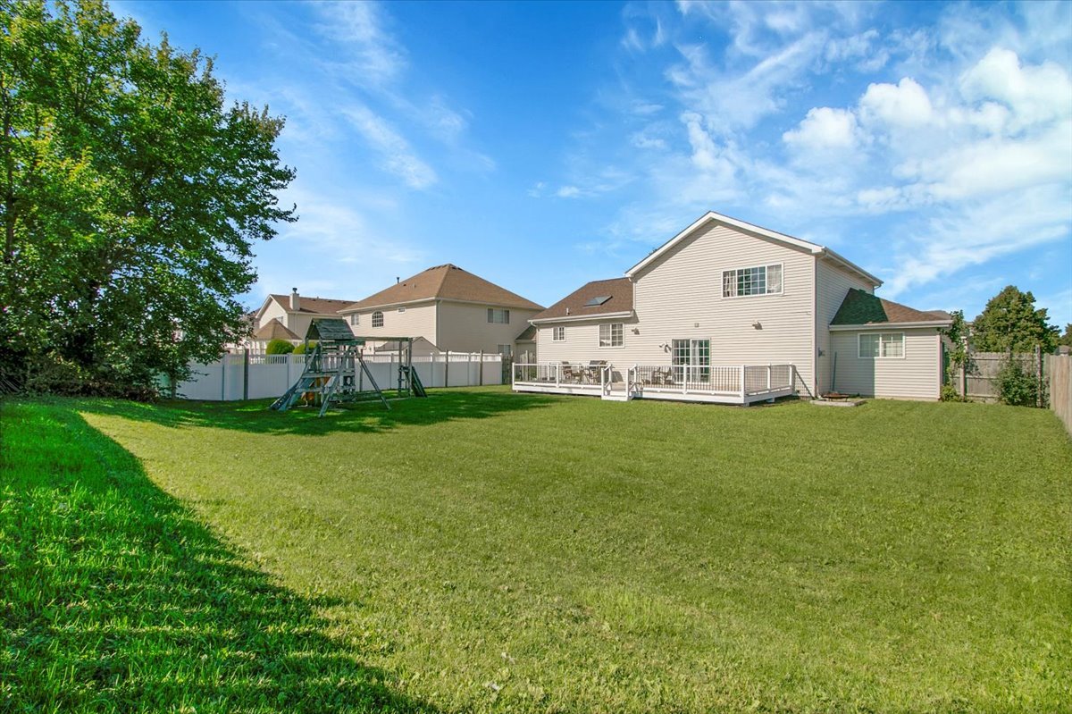 663 Primrose Lane Matteson, IL 60443 - Photo 28 of 32 a view of a white house with a big yard and large trees