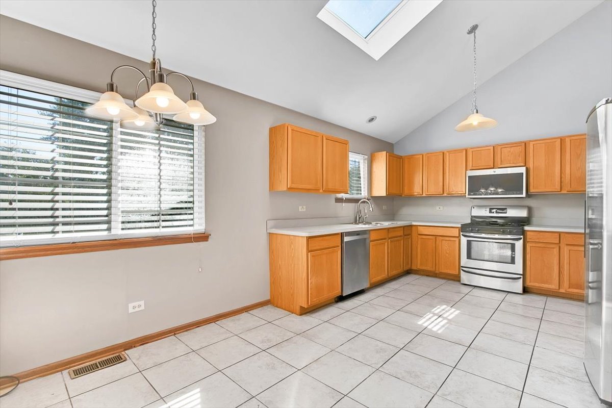 663 Primrose Lane Matteson, IL 60443 - Photo 6 of 32 a kitchen with stainless steel appliances granite countertop a stove a sink dishwasher and a refrigerator