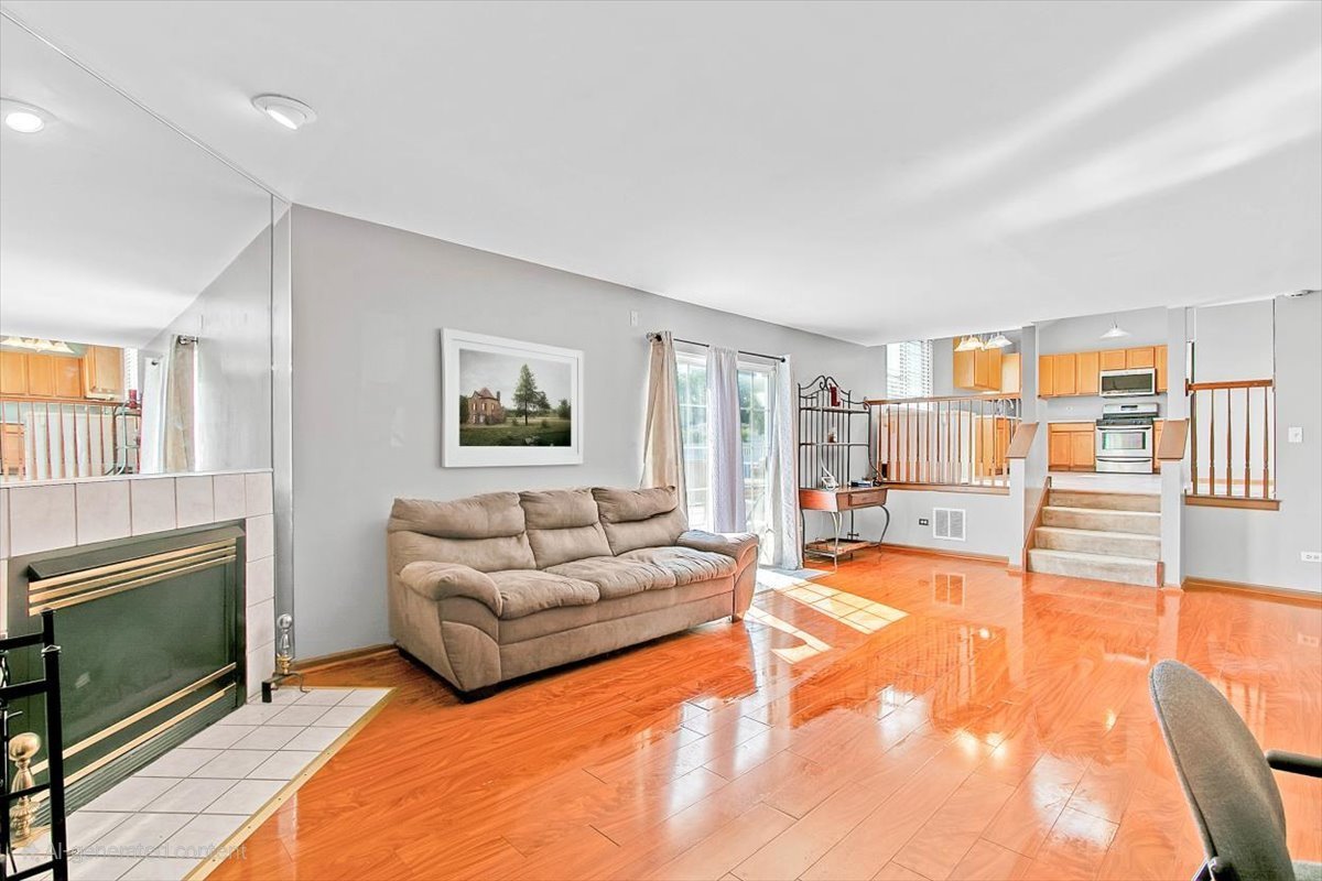 663 Primrose Lane Matteson, IL 60443 - Photo 10 of 32 a living room with furniture and a fireplace