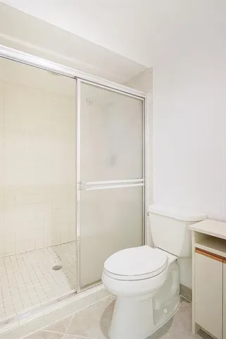 a bathroom with a toilet and a shower