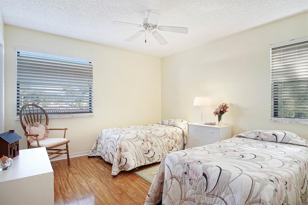 6081 Southeast Landing Way, Unit 9 Stuart, FL 34997 - Photo 16 of 31 a bedroom with two beds and a table