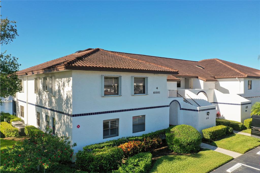 6081 Southeast Landing Way, Unit 9 Stuart, FL 34997 - Photo 2 of 31 a house view with a garden space