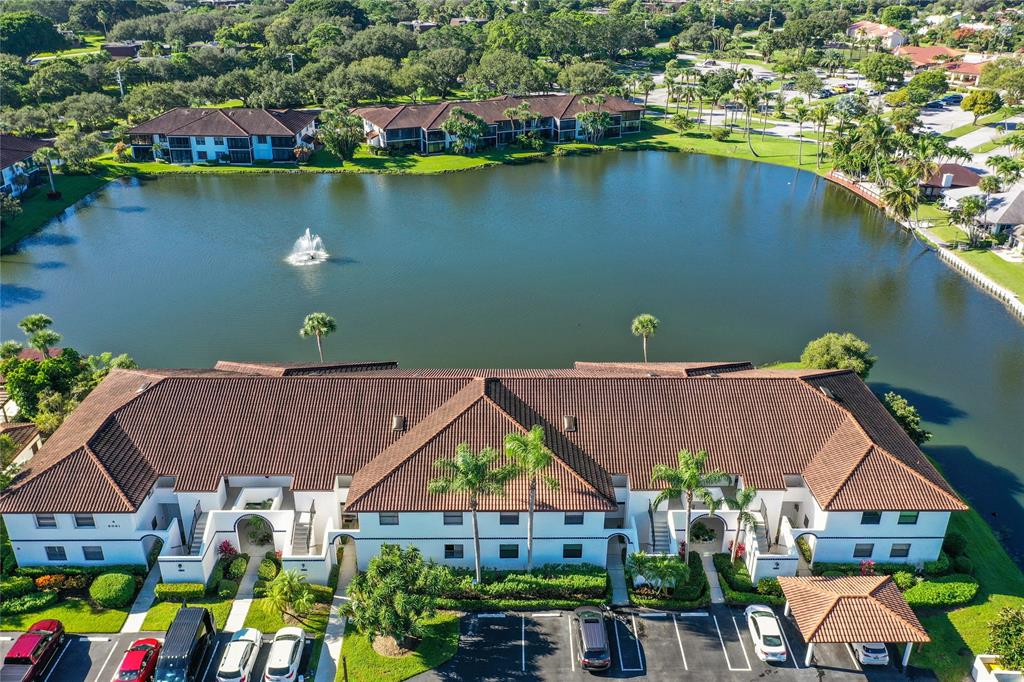 6081 Southeast Landing Way, Unit 9 Stuart, FL 34997 - Photo 23 of 31 an aerial view of a house with a garden and lake view