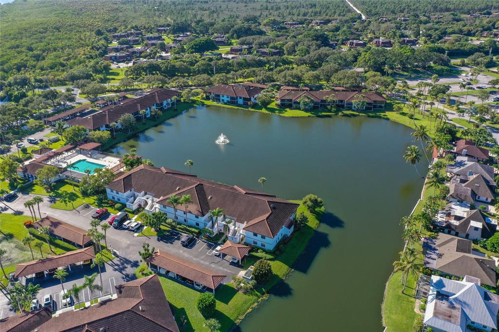 6081 Southeast Landing Way, Unit 9 Stuart, FL 34997 - Photo 25 of 31 an aerial view of lake and residential houses with outdoor space