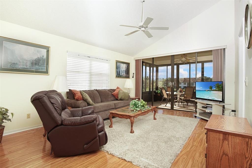 6081 Southeast Landing Way, Unit 9 Stuart, FL 34997 - Photo 3 of 31 a living room with furniture and a flat screen tv