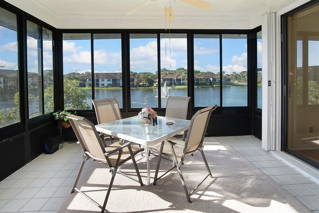 6081 Southeast Landing Way, Unit 9 Stuart, FL 34997 - Photo 4 of 31 a dining room with furniture and large windows