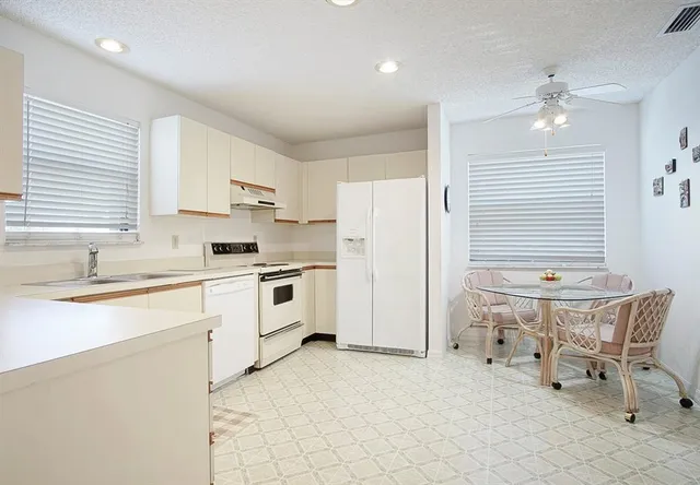 a kitchen with a sink cabinets and window