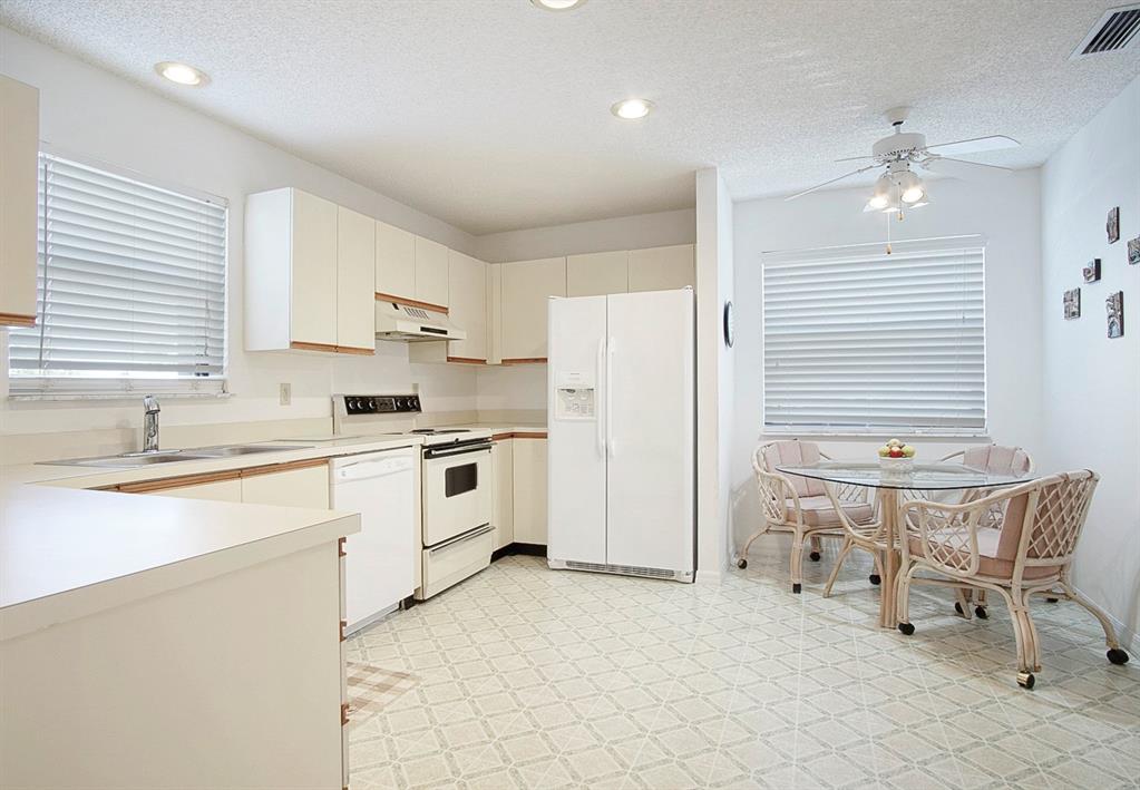 6081 Southeast Landing Way, Unit 9 Stuart, FL 34997 - Photo 6 of 31 a kitchen with a sink cabinets and window