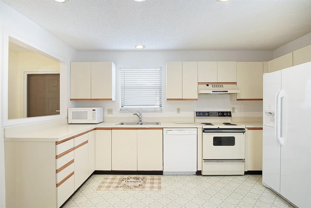 6081 Southeast Landing Way, Unit 9 Stuart, FL 34997 - Photo 8 of 31 a kitchen with white cabinets sink and white appliances