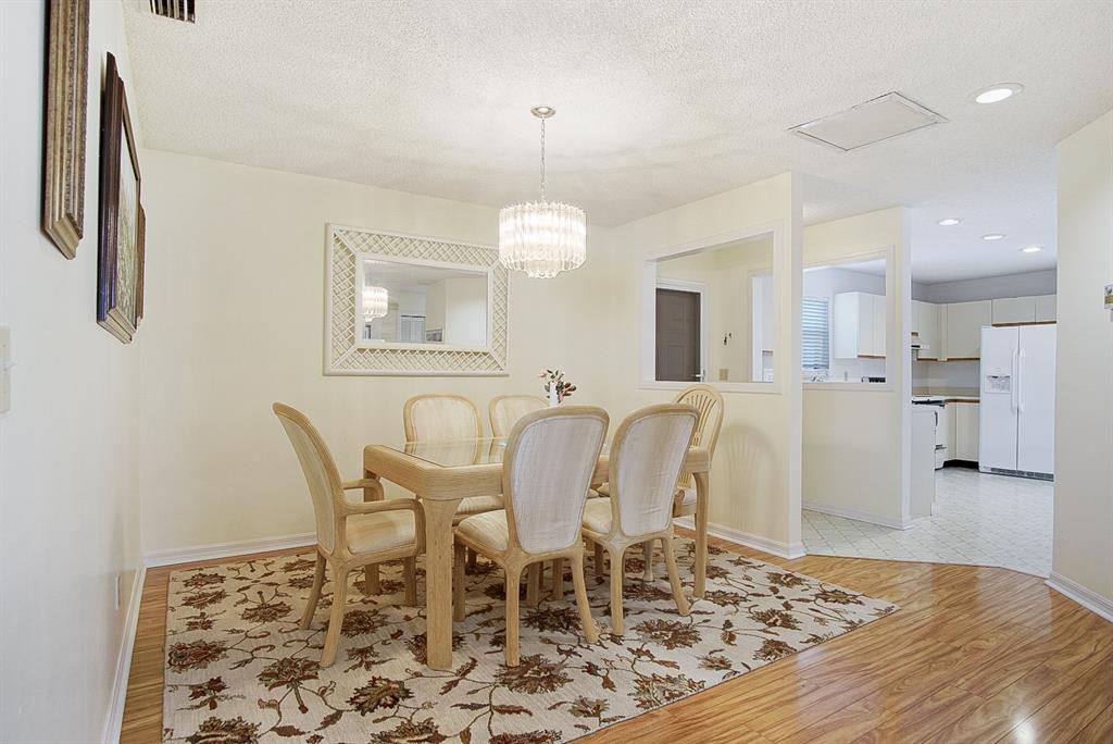 6081 Southeast Landing Way, Unit 9 Stuart, FL 34997 - Photo 9 of 31 a view of a dining room with furniture and wooden floor