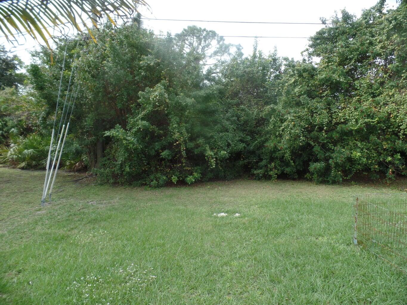 4210 Southwest Utterback Street Port St. Lucie, FL 34953 - Photo 2 of 7 a view of a backyard with green space