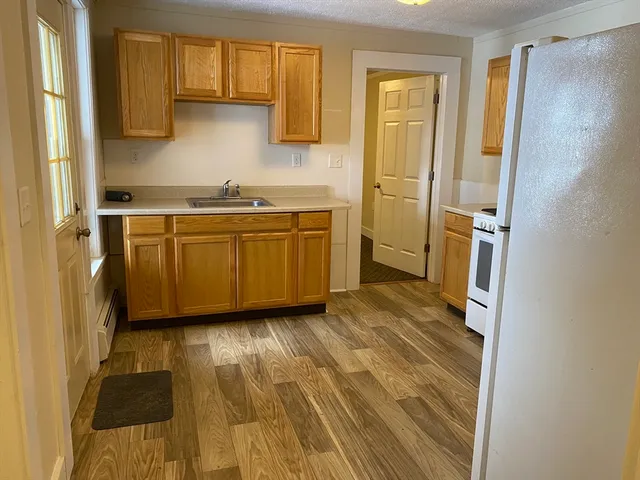 a kitchen with granite countertop a sink and a stove top oven
