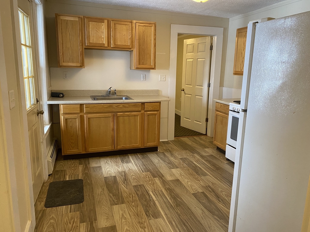 a kitchen with granite countertop a sink and a stove top oven