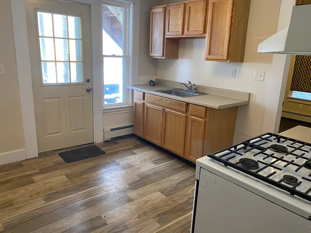 a kitchen with wooden floors and a stove top oven