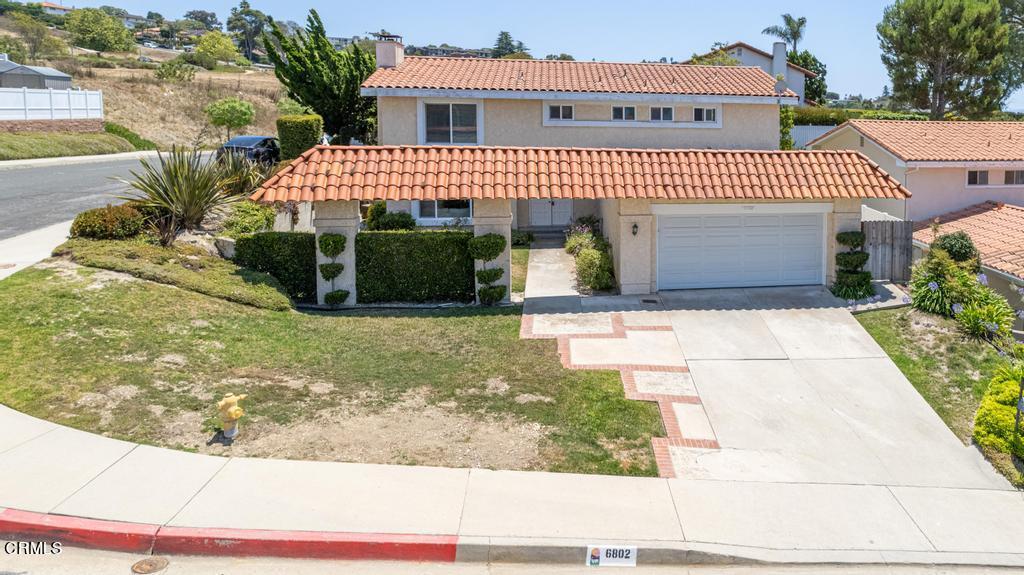 6802 Verde Ridge Road Rancho Palos Verdes, CA 90275 - Photo 2 of 46 a view of a white house with large windows and a yard with plants