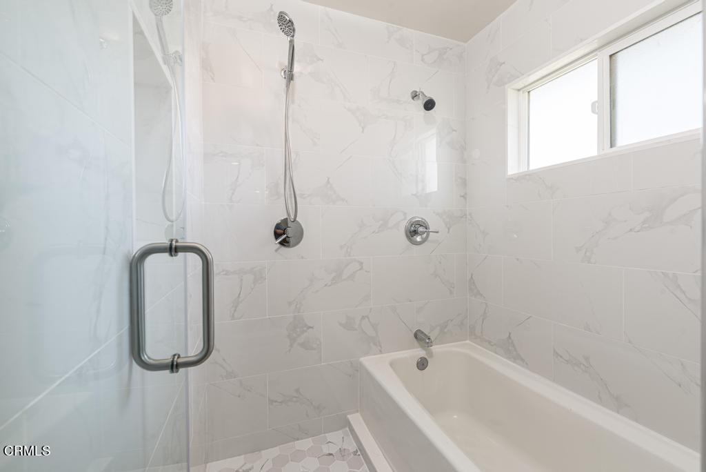 6802 Verde Ridge Road Rancho Palos Verdes, CA 90275 - Photo 30 of 46 a bathroom with a tub shower and a window