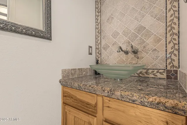 a kitchen with granite countertop stainless steel appliances a refrigerator stove top oven and sink