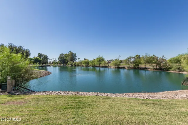 a view of a lake with houses in the background