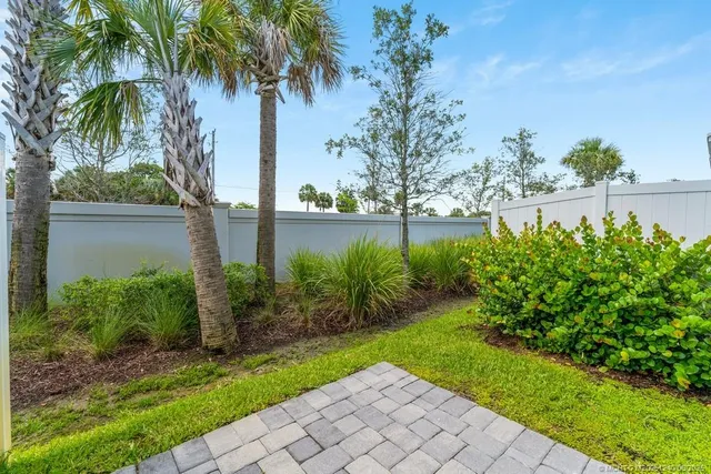 a view of a yard with a house in the background