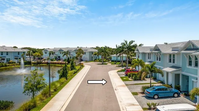 a view of a lake with a swimming pool and furniture