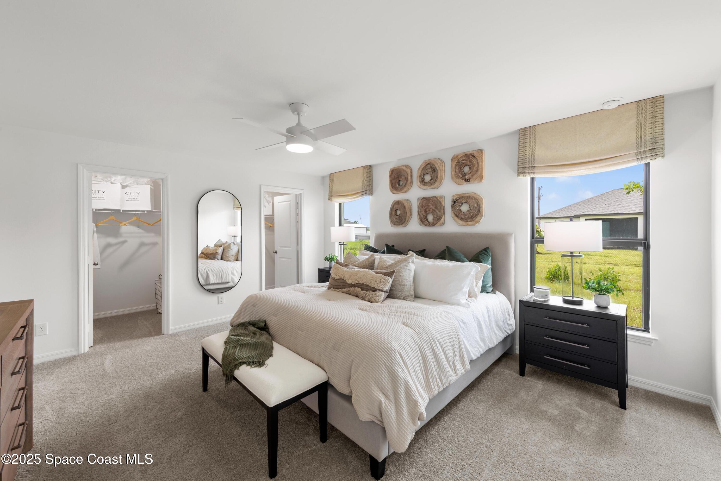 2847 Digby Road Southeast Palm Bay, FL 32909 - Photo 8 of 14 a bedroom with a bed and a chandelier