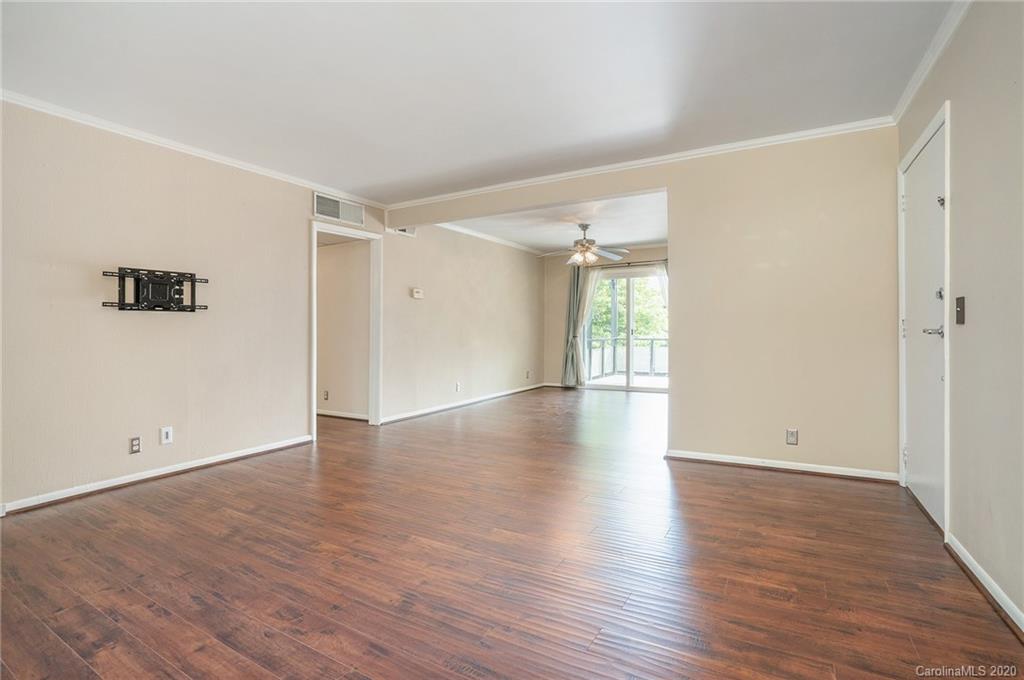 2628 Park Road, Unit H Charlotte, NC 28209 - Photo 1 of 39 an empty room with wooden floor and windows
