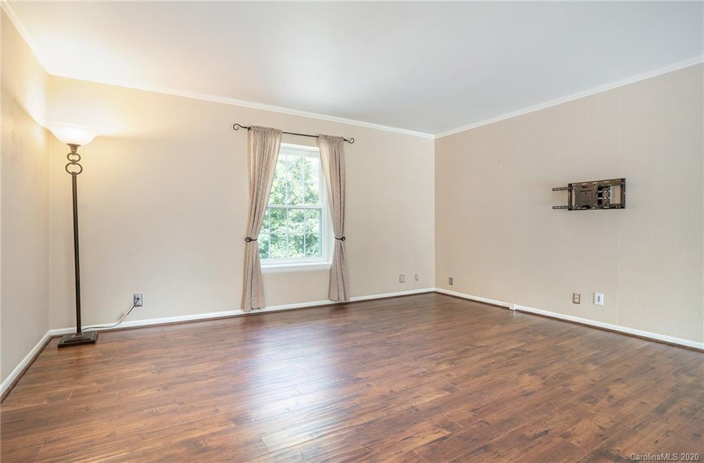 2628 Park Road, Unit H Charlotte, NC 28209 - Photo 2 of 39 an empty room with wooden floor and windows