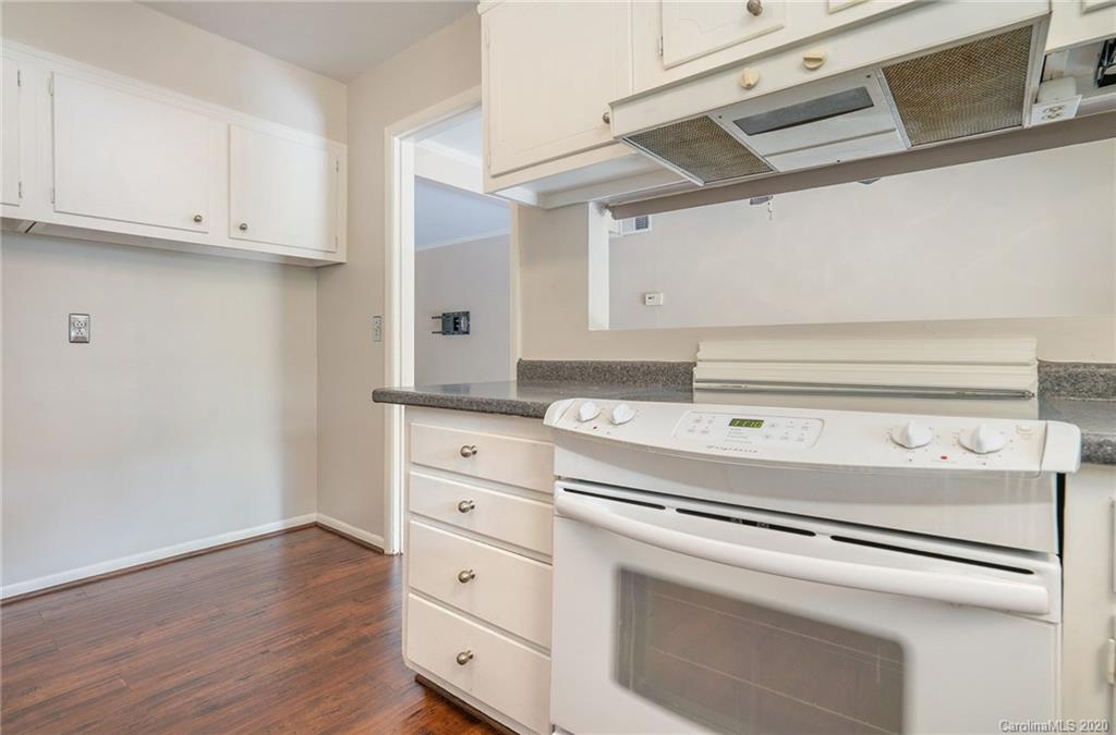 2628 Park Road, Unit H Charlotte, NC 28209 - Photo 13 of 39 a kitchen with granite countertop white cabinets and white appliances