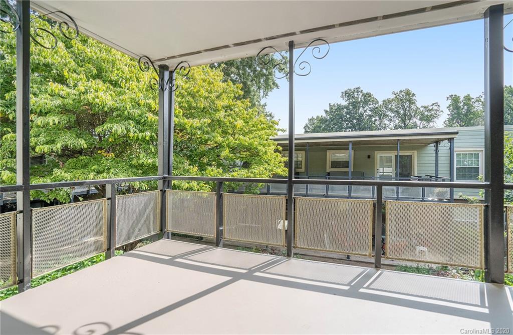 2628 Park Road, Unit H Charlotte, NC 28209 - Photo 14 of 39 a view of a balcony with floor to ceiling windows with wooden floor