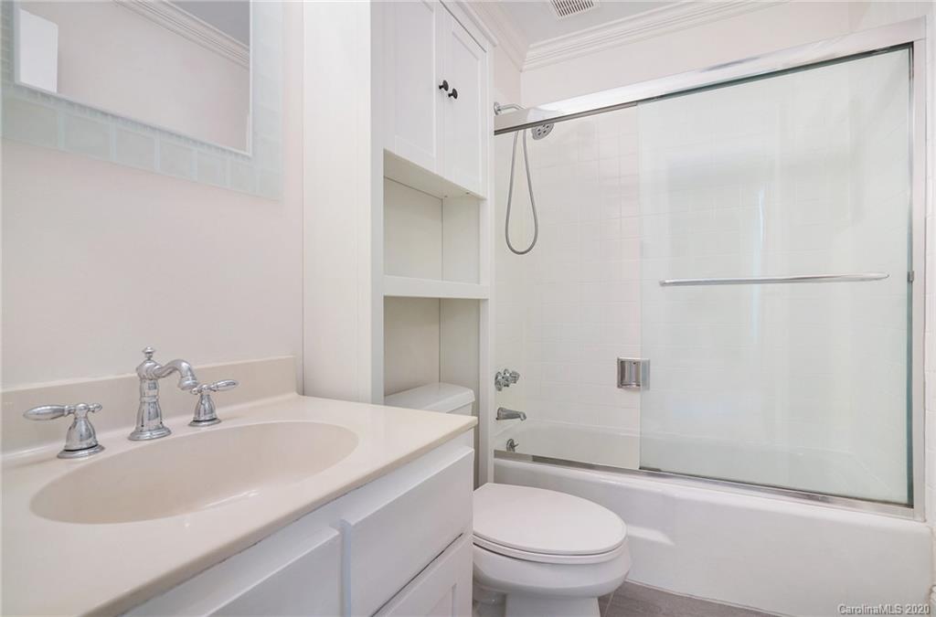 2628 Park Road, Unit H Charlotte, NC 28209 - Photo 18 of 39 a bathroom with a granite countertop sink toilet and shower